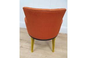 A chair with yellow protective netting covering the chair legs