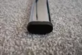 A black plastic oval tube insert. Fitted into the end of a oval chrome tube.
