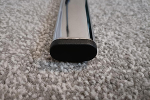A black plastic oval tube insert. Fitted into the end of a oval chrome tube.