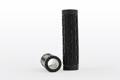 Side view of two black plastic patterned industrial grip handles that are open both ends. One is upright, the other on its side.