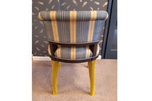 A chair with yellow protective netting covering the chair legs.